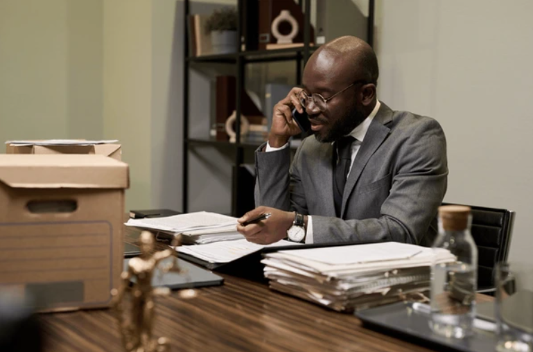 Nigerian lawyer using best legal research tools for Nigerian lawyers at a modern office desk